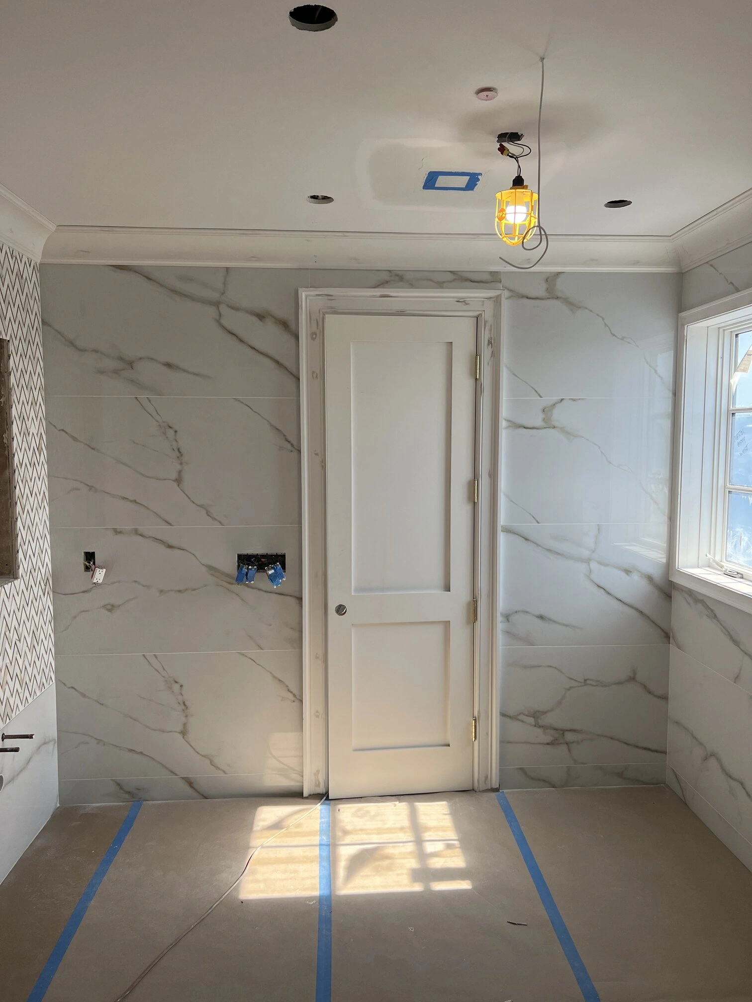 Bathroom herringbone tile and large format marble tiles